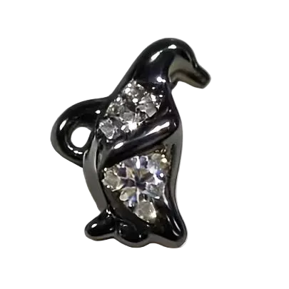 Black animal-shaped charm with embedded crystals on a white background