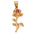 Gold rose-shaped pendant with a red gemstone on a beige background