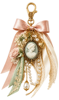 An ornate vintage-style keychain charm featuring a large blush pink satin bow, cream lace, a pale green ribbon, faux pearls, a small pink rose, and a central oval cameo face in an antique gold frame, all attached to a gold lobster clasp on a white background.