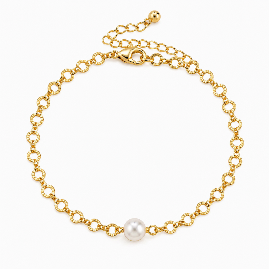 Gold bracelet with a single pearl on a white background