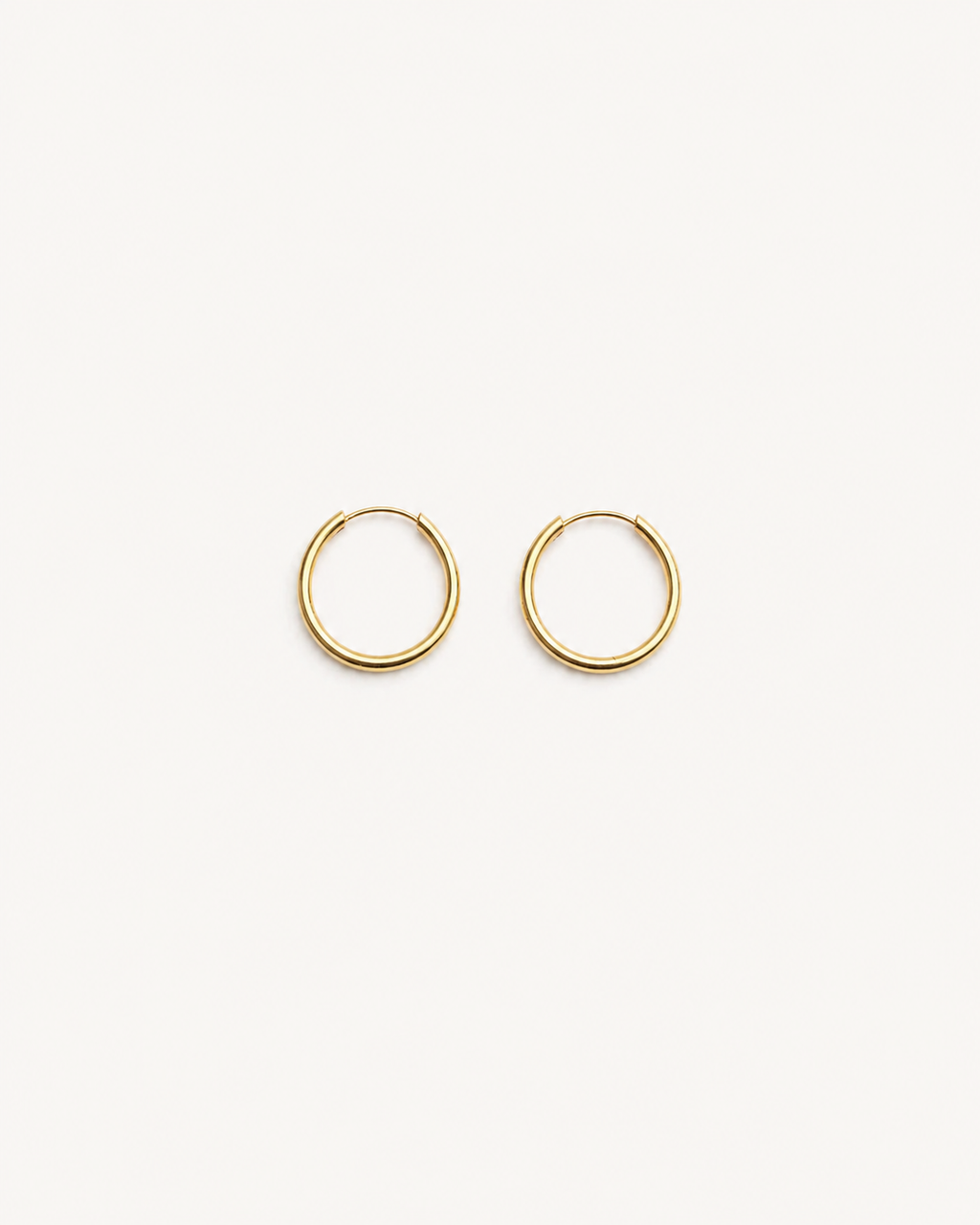 Gold hoop earrings on a white background