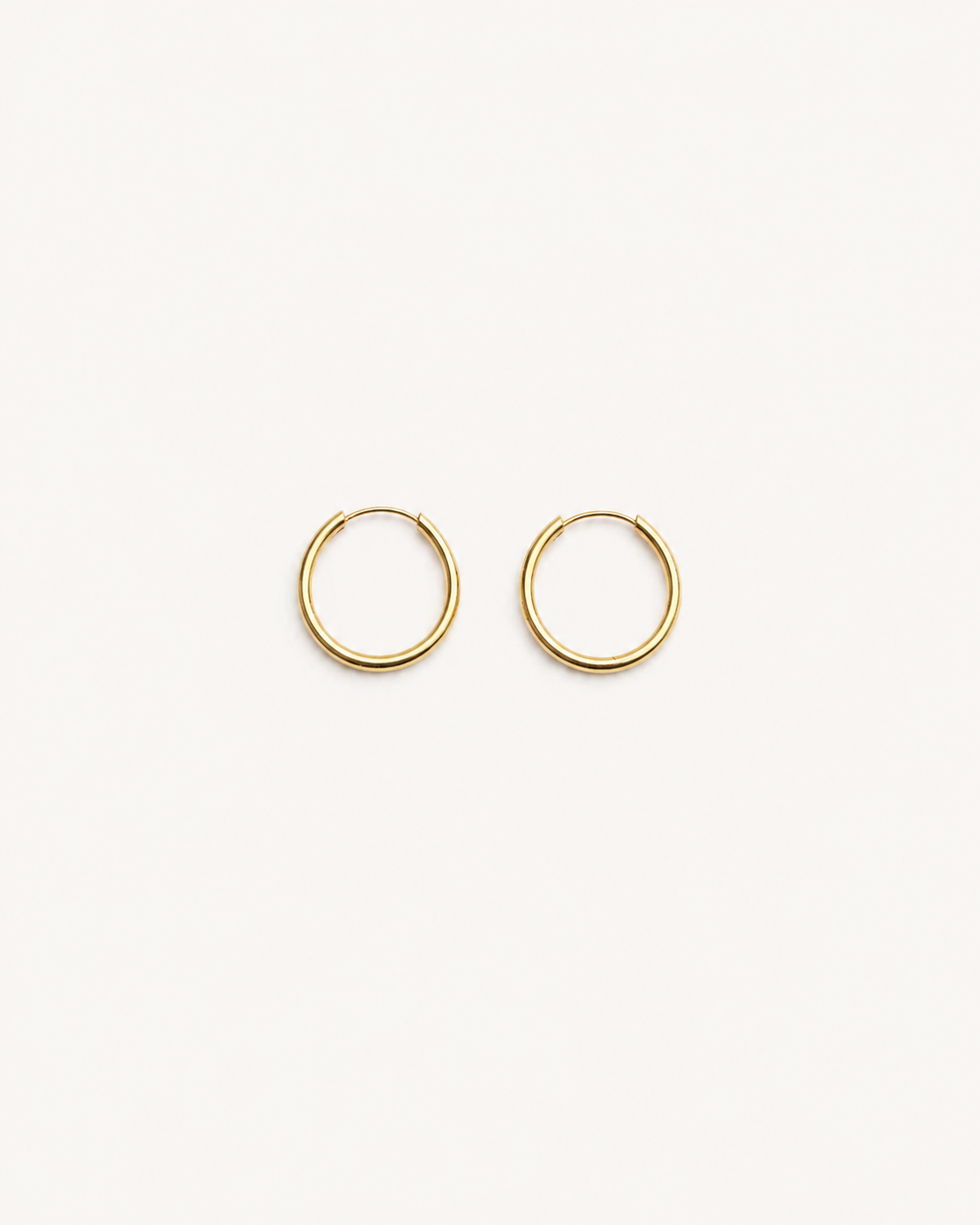 Gold hoop earrings on a white background