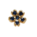 Gold flower-shaped charm with blue gemstones on a white background