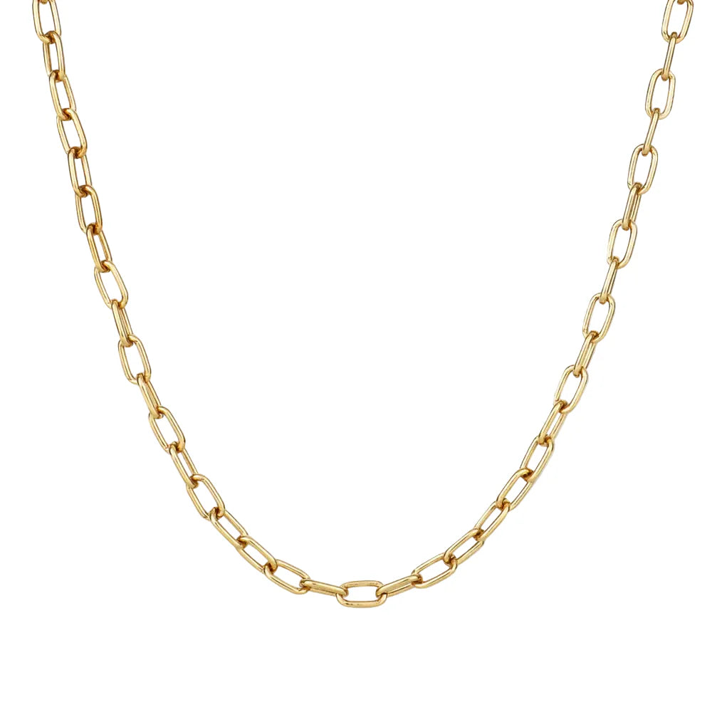 Gold chain necklace on a light beige background