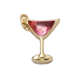Gold charm shaped like a cocktail glass with a pink gem on a white background