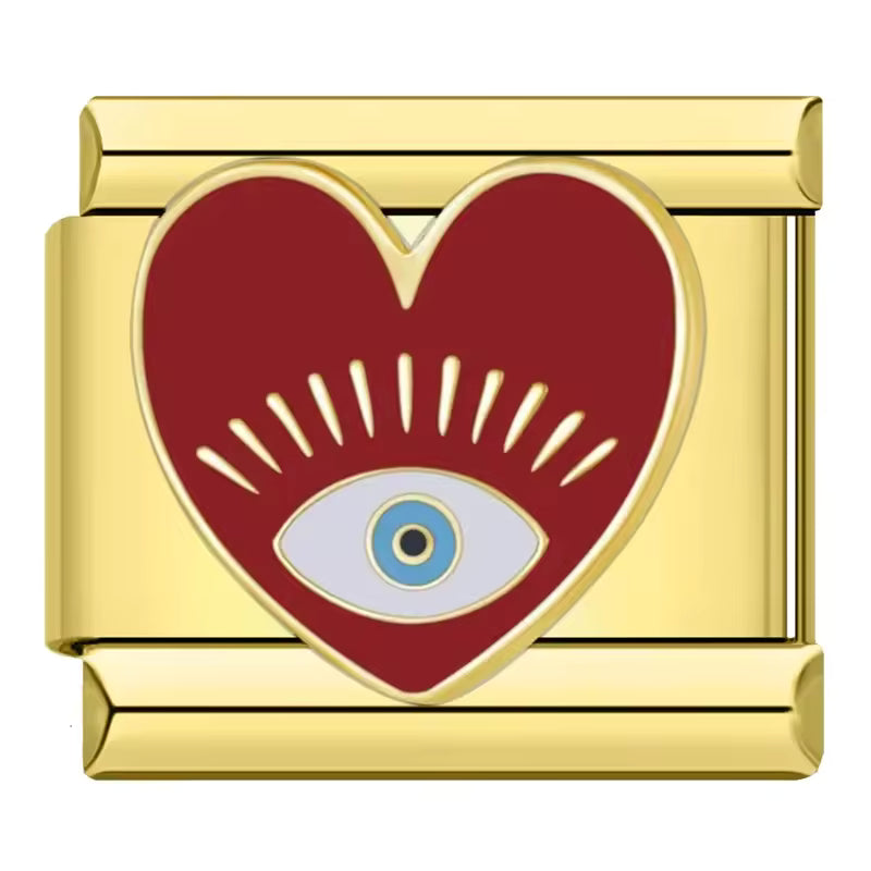 Gold charm with a red heart and blue eye design on a white background