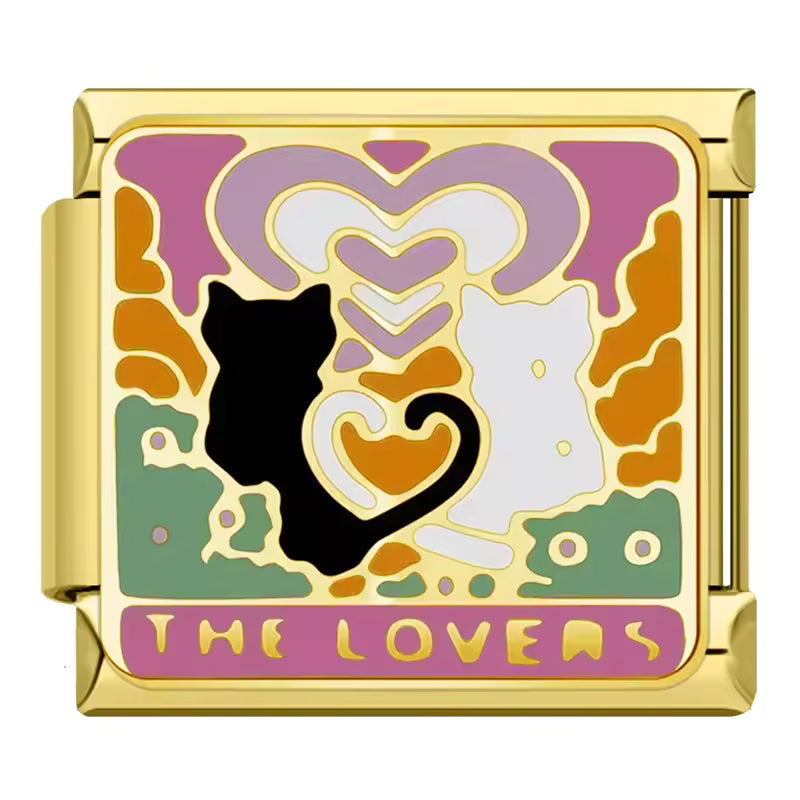 Decorative charm with cats and 'The Lovers' text on a gold border
