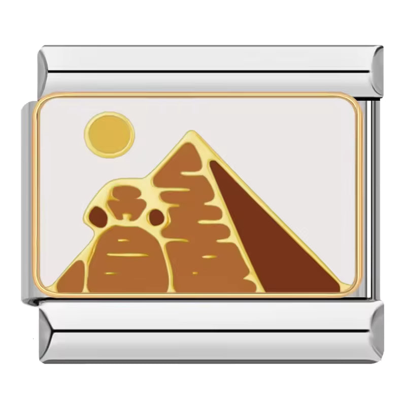 Gold pyramid and sun design on a silver and gold charm with white background
