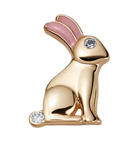 Gold bunny-shaped earring with pink accents on a white background