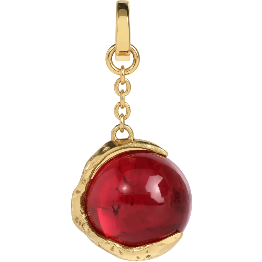 Gold pendant with a red gemstone on a light gray background
