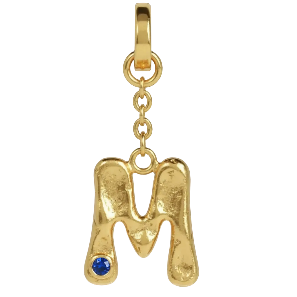 Gold pendant shaped like the letter 'M' with a blue gemstone