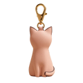 Pink cat-shaped keychain on a beige background